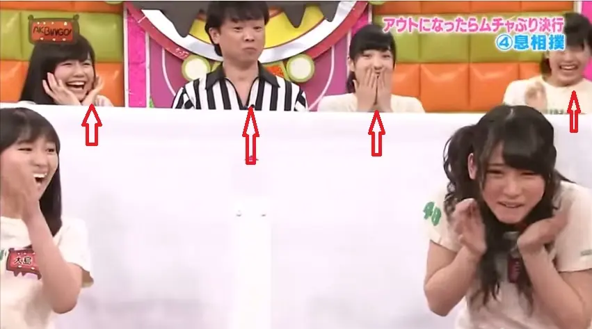 Loco juego japonés. Dos chicas soplan cucaracha